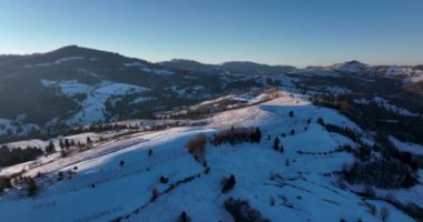 Snow-covered mountain peak, cinematic view, forestand mountain background. High-quality DJI Mavic 3 5.1k and 4k footage in January 2022 in Borsa, Romania a town in eastern Maramures County