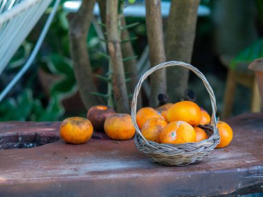 Basket and orange on table 