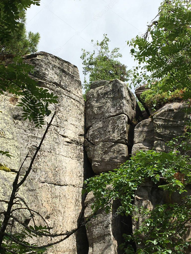 Kamenny Gorod  is a complex of rocks on one of the peaks of the Rudyansky Spoy ridge (526 meters), located in the Perm Krai. Millions of yeas ago, a river flowed in this place, which washed channels in the sandy rocks now streets and alleys