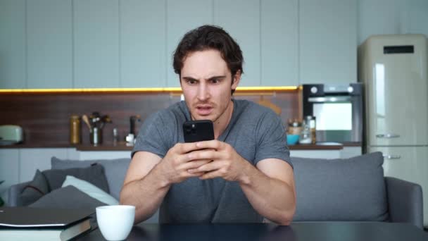 Enfoque suave en el cambio de las emociones faciales de un hombre, aterrorizado, estupefacto y sensación de horror al recibir noticias terribles. Hombre guapo molesto, preocupado, ansioso por el pánico leyendo información en pantalla — Vídeo de stock