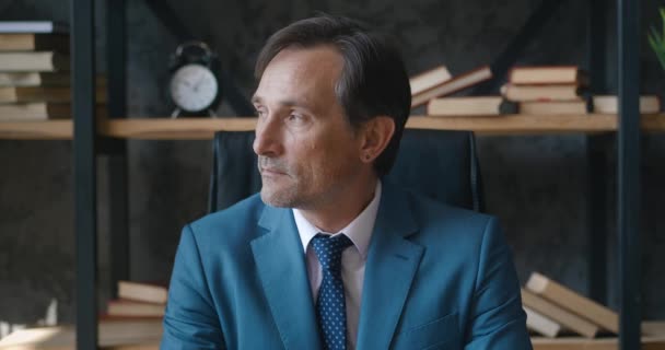 Portrait of serious mature professional CEO businessman looking at camera. Confident adult entrepreneur, leader, manager sitting in office — Stock Video
