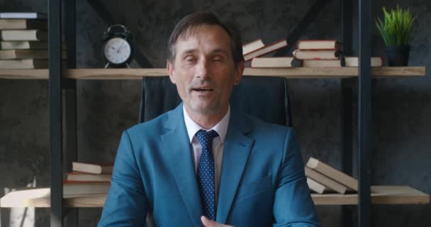 Portrait Headshot d'homme d'affaires PDG mature fournir une consultation en ligne à l'aide de vidéocall tout en étant assis au bureau — Video