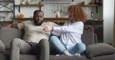 Genç bir kadın genç bir kocaya pozitif hamilelik testi gösteriyor. Adam planlanmamış hamilelik yüzünden üzgün ve mutsuz. Çift kanepede birbirine karşı oturur.