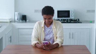 Beautiful young woman using her smartphone, checking news feed and social media content. Online communication concept