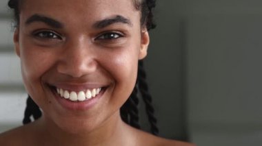 Close-up. Natural beauty woman with fresh glowing skin, cutely smiling looking at camera. Femininity, sensuality concept