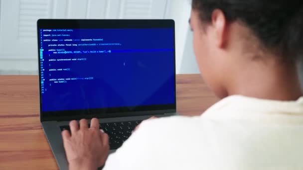 Rear View Programmer Using Laptop Writes Computer Programs Sitting Wooden – Stock-video