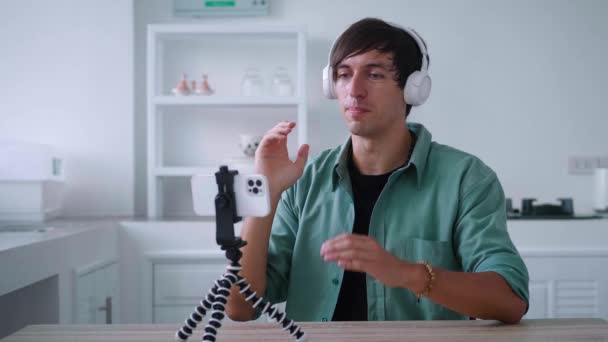 Man Wireless Headphones Talking Video Call Using His Mobile Phone — Vídeos de Stock