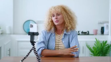 Sevimli bir kadın, sevimli bir gülümseme neşeli dişli bir gülümseme video bağlantısıyla konuşurken..