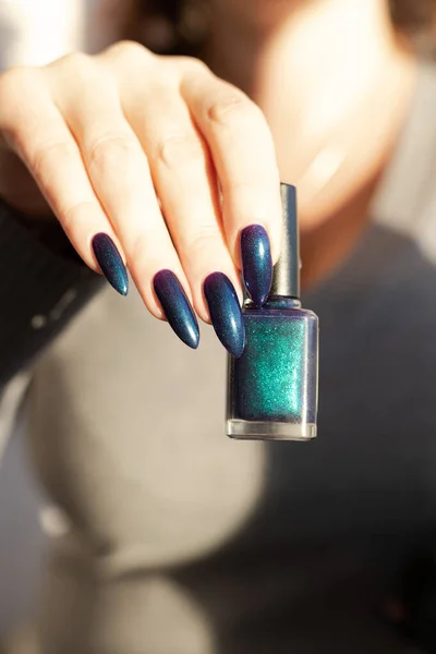cropped image of woman with beautiful fresh colored manicure