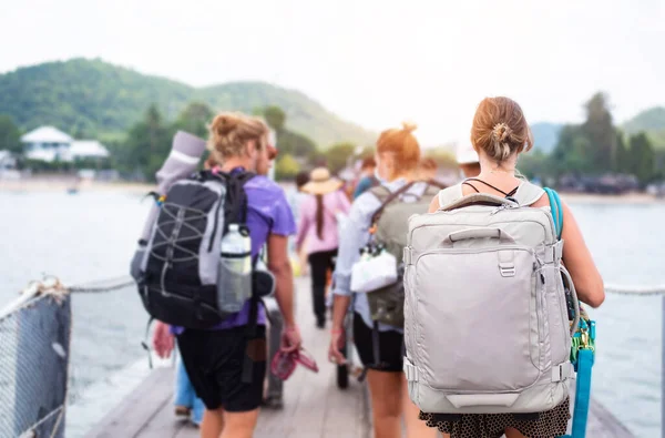 Sırt çantalı gezginler limanda bekliyor, sırt çantalı gezginler açık havada rıhtımda rahatça bekliyorlar. Yaz tatili.