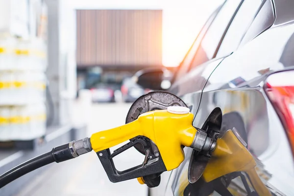 Refilling the car with fuel at the gas station and blurry staff background, refilling the car with fuel at the refuel station, the concept of fuel energy, Blurry image for background.