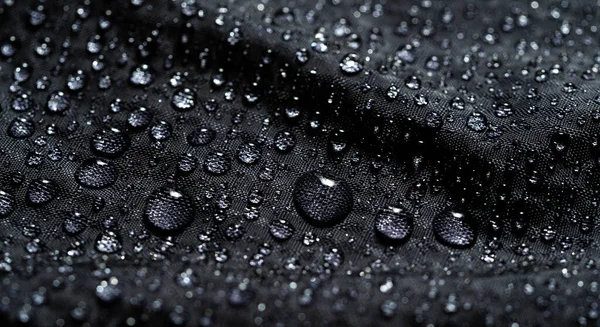 Fundo de revestimento impermeável com gotas de água. gotas de água na capa de chuva. — Fotografia de Stock