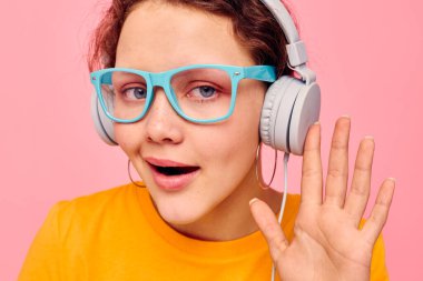 Kulaklık takan güzel bir kadın. Mavi gözlükler. Yakın çekim duyguları.