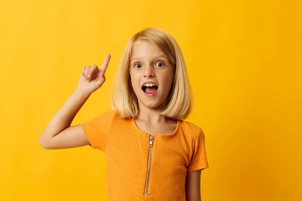 Joyful girl with blond hair gesturing with her hands — Stockfoto