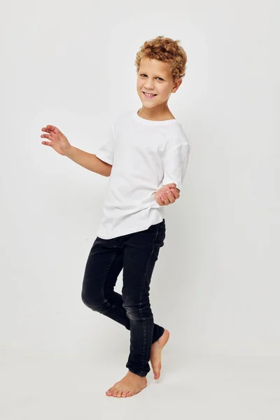Boy in a white t-shirt barefoot in full growth — Foto Stock