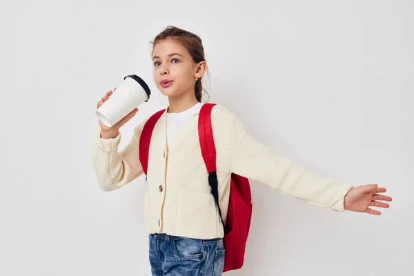 Little girl hand gesture red backpack light background — Foto de Stock