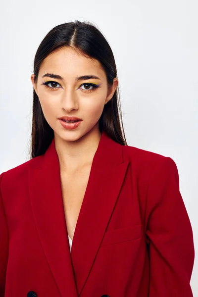 Beautiful brunette bright makeup red jacket posing studio model unaltered — Stockfoto