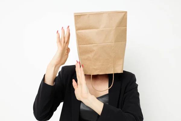 Portrait of a woman with a bag on his head in a black jacket red nail polish isolated background — Stock fotografie