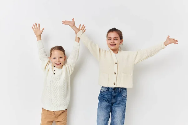 Two friends are standing side by side fun childhood light background — Stockfoto