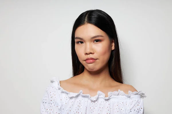 Cute asian woman in white shirt posing fashion on light background — Stockfoto