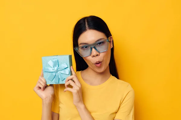 Charming young Asian woman in stylish glasses a gift fun studio model unaltered — Stock Photo, Image