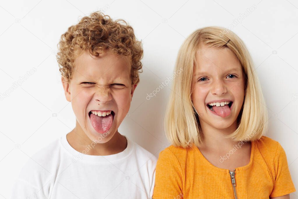 two joyful children casual clothes posing emotions studio isolated background unaltered