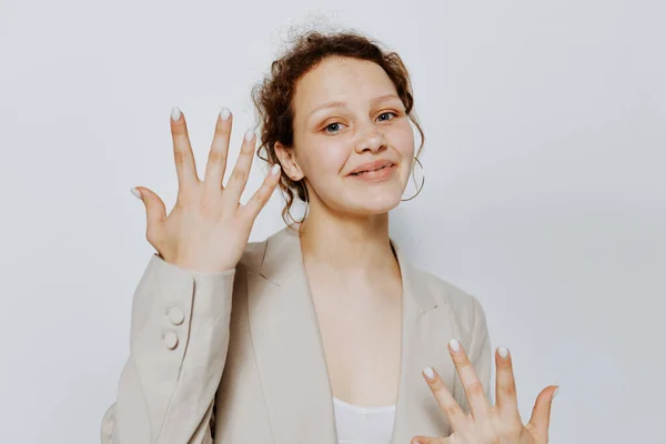 Portrait of a young woman in a suit gestures with his hands isolated backgrounds unaltered — Fotografia de Stock