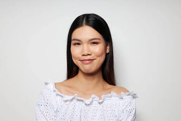 Cheerful asian posing fashion studio model light background — Stockfoto