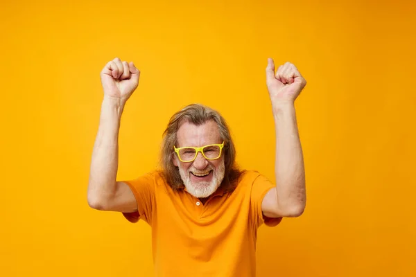 Senior grey-haired man hand gestures emotions yellow glasses monochrome shot — Photo