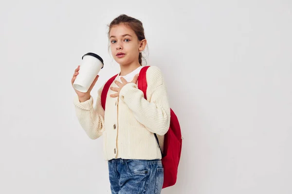 Little girl hand gesture red backpack light background — Foto de Stock