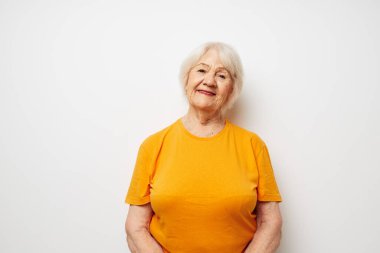 Portrait of an old friendly woman holding a glass of water health close-up emotions