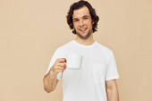 man with a white mug in his hands emotions posing isolated background