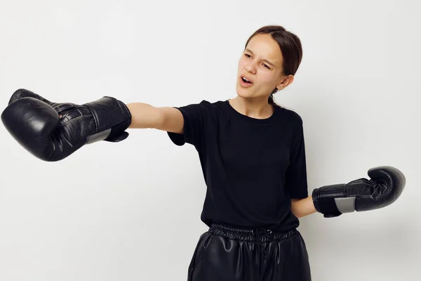 Beautiful girl in black sports uniform boxing gloves posing isolated background — Φωτογραφία Αρχείου