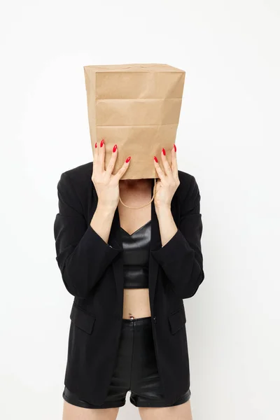 Photo pretty woman with a bag on his head in a black jacket red nail polish Lifestyle unaltered — 图库照片