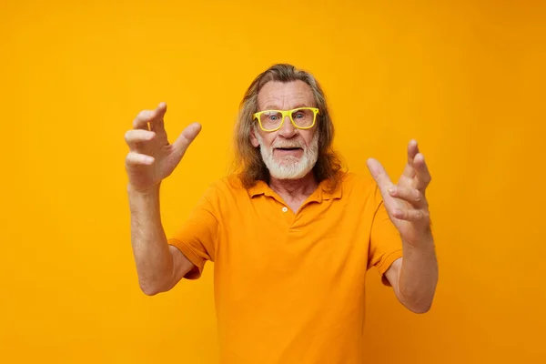 Senior grey-haired man hand gestures emotions yellow glasses monochrome shot — Photo