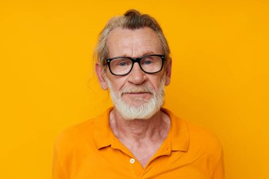 cheerful old man gray beard glasses yellow background