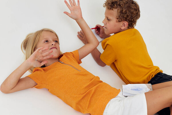 Cute stylish kids emotions drawing together notepad and pencils childhood lifestyle unaltered