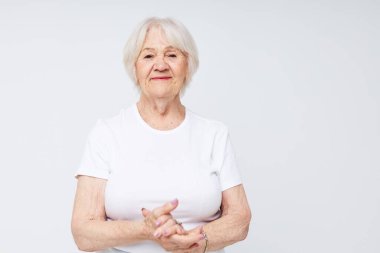 elderly woman in a white t-shirt light background