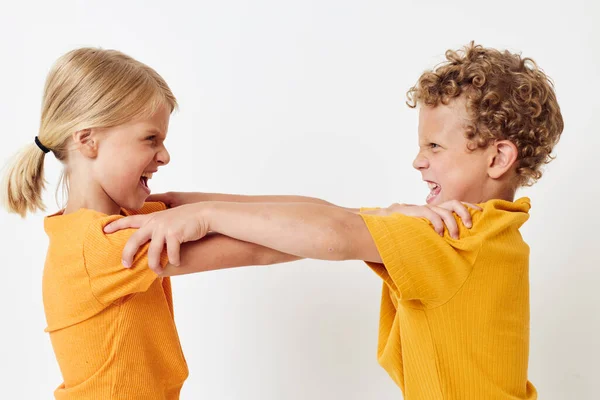 stock image Small children in yellow t-shirts standing side by side childhood emotions light background unaltered