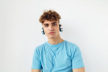 Mavi tişörtlü, sapkın adam kulaklık takıyor, yaşam tarzını değiştirmemiş.