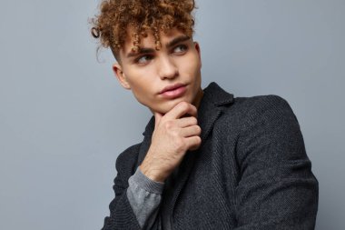 Çekici erkek seksi poz veren ceket kendine güvenen izole bir arka plan.