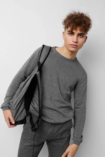 Pohledný chlap v šedém svetru batoh módní izolované pozadí — Stock fotografie