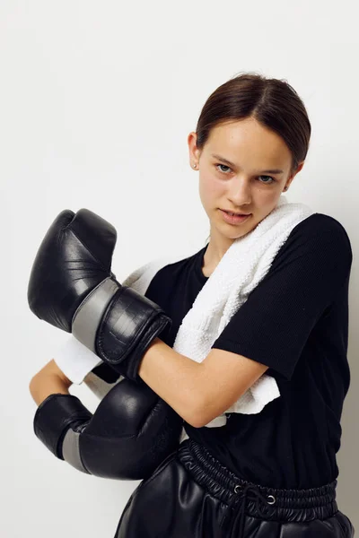 Young woman in black sports uniform boxing gloves towel Lifestyle unaltered — 图库照片