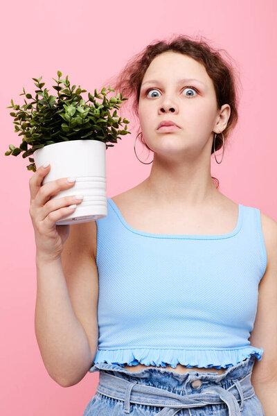 pretty girl flower in white pot posing emotion cropped view unaltered
