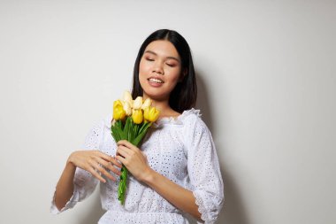 Bir buket çiçekle büyüleyici genç Asyalı kadın yakından gülümse. Değişmemiş yaşam tarzı.