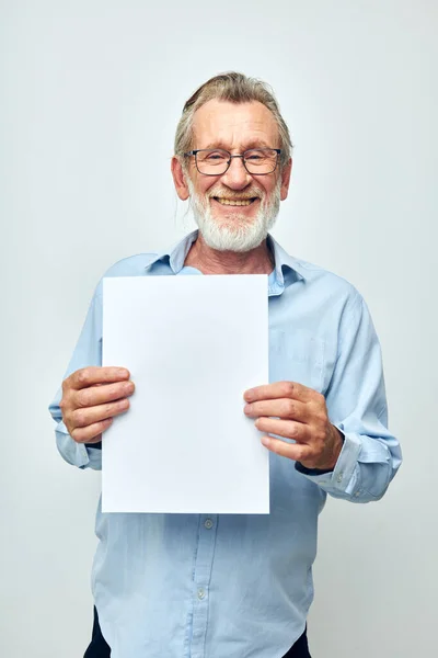Yaşlı adam ofis belgeleri hafif arka planda çalışır — Stok fotoğraf