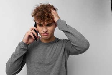 Yakışıklı adam telefon modasına bakıyor. Yaşam tarzı değişmemiş.