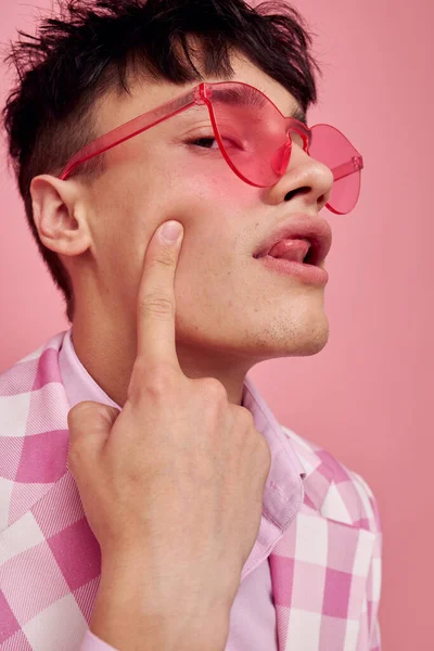 Portrét mladého muže módní růžové sluneční brýle bunda pózování růžové pozadí beze změny — Stock fotografie