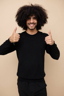 Siyah kazaklı çekici bir adam. El hareketi. Yaşam tarzı değişmemiş.