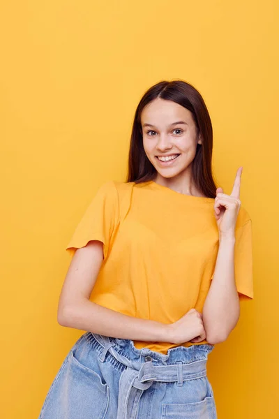 Young beautiful woman in a yellow t-shirt emotions summer style isolated background — Stock Photo, Image
